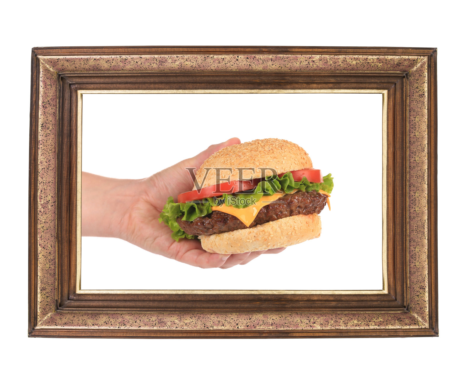 在框架中手持汉堡包。照片摄影图片