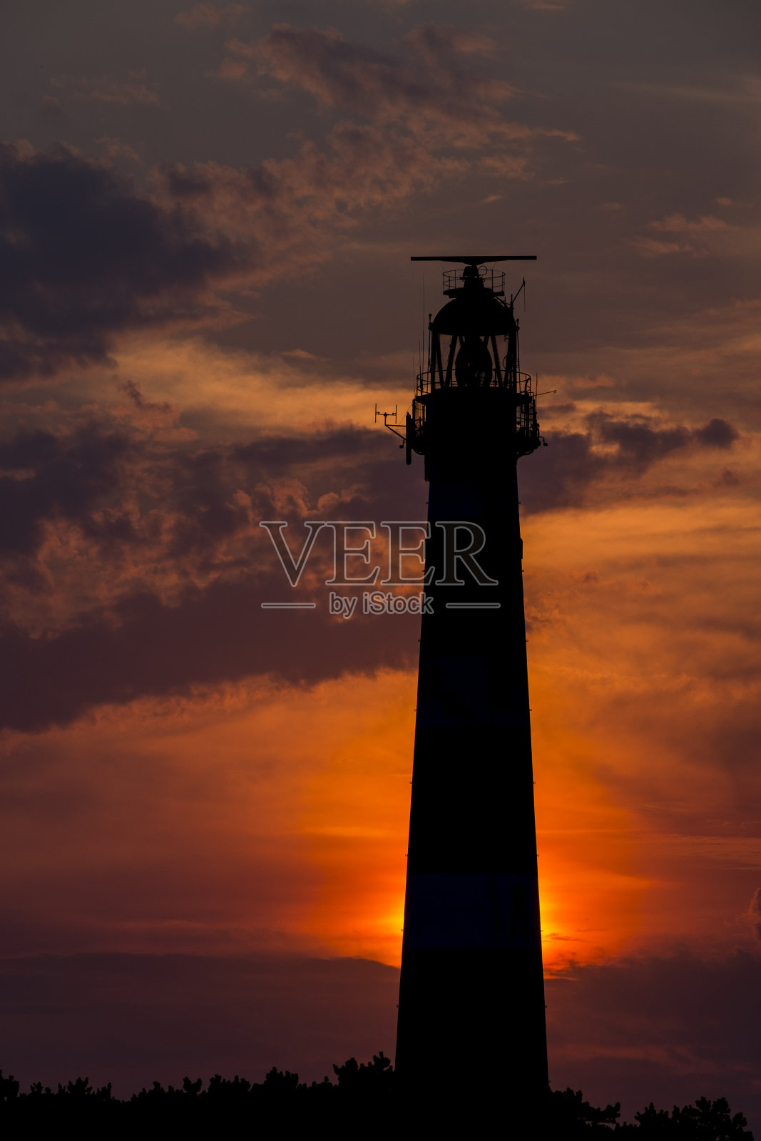 红色天空日落时的阿米兰灯塔照片摄影图片