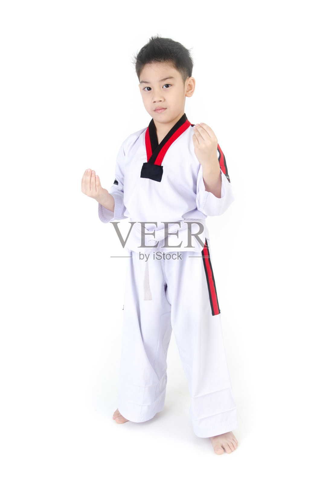 跆拳道动作由一个亚洲可爱的男孩照片摄影图片