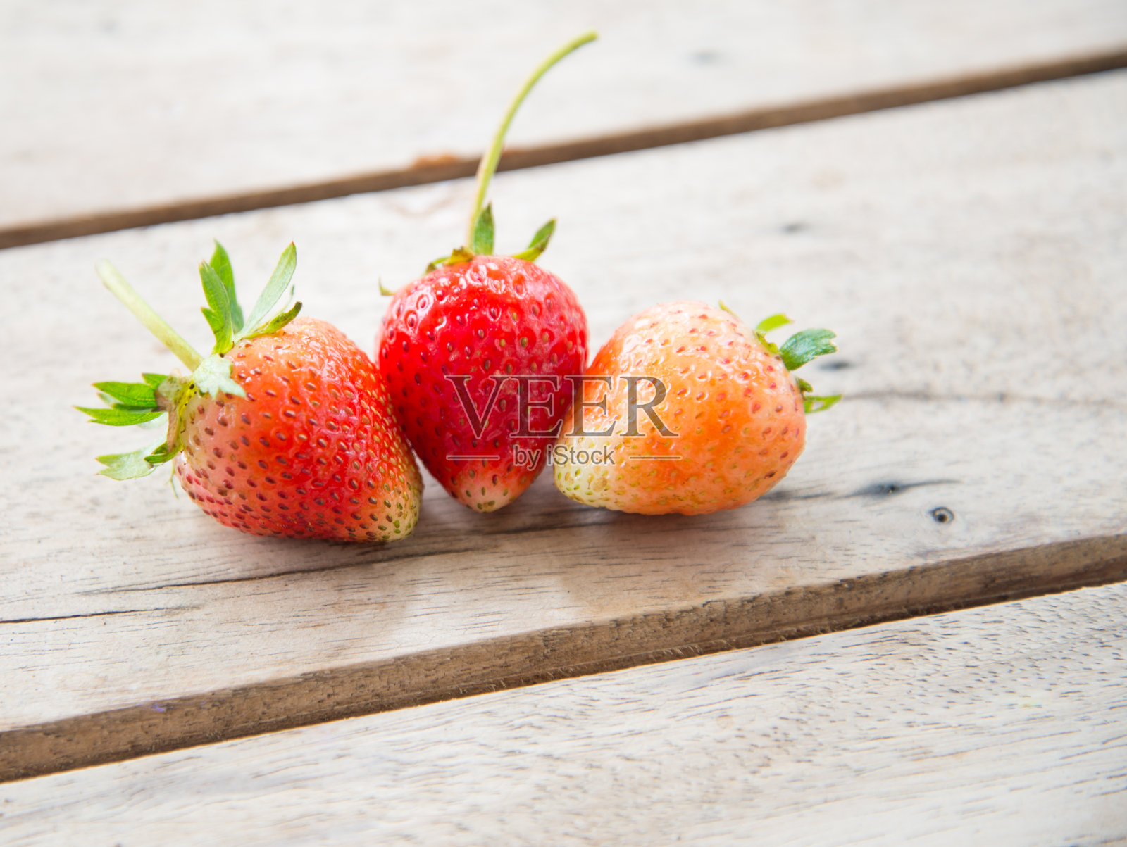 木桌上放着成熟的红草莓照片摄影图片