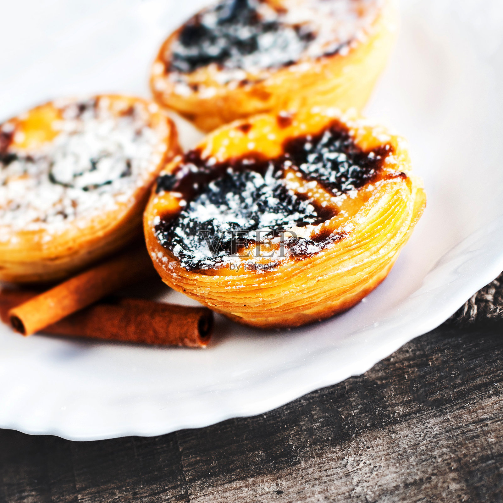 蛋挞奶油甜蛋挞放在白色盘子上，木桌靠近复印空间。贝伦酱甜点照片摄影图片