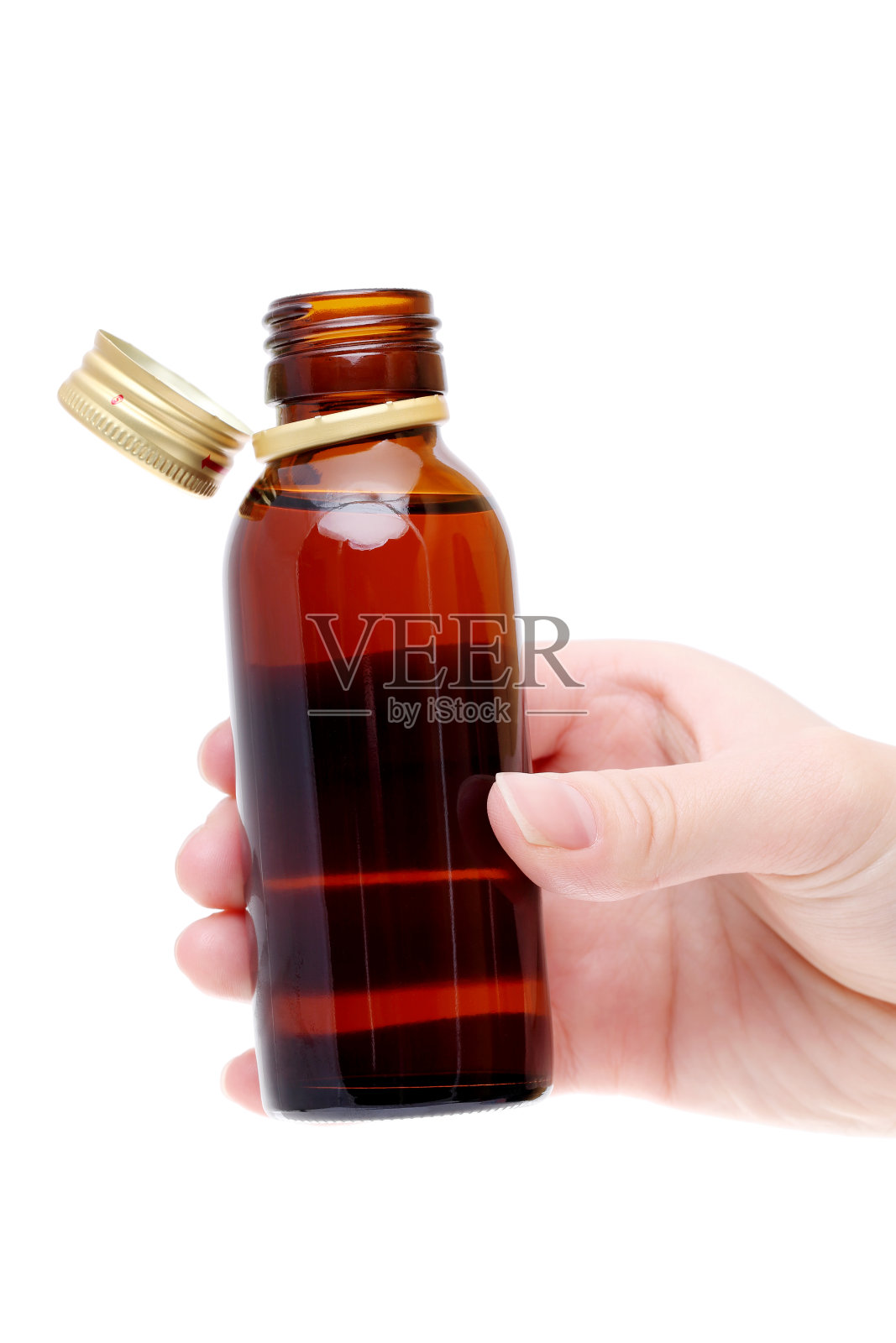 手拿棕色药瓶照片摄影图片