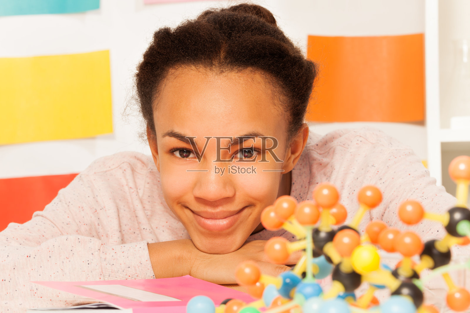 有分子结构的女学生坐在书桌前照片摄影图片