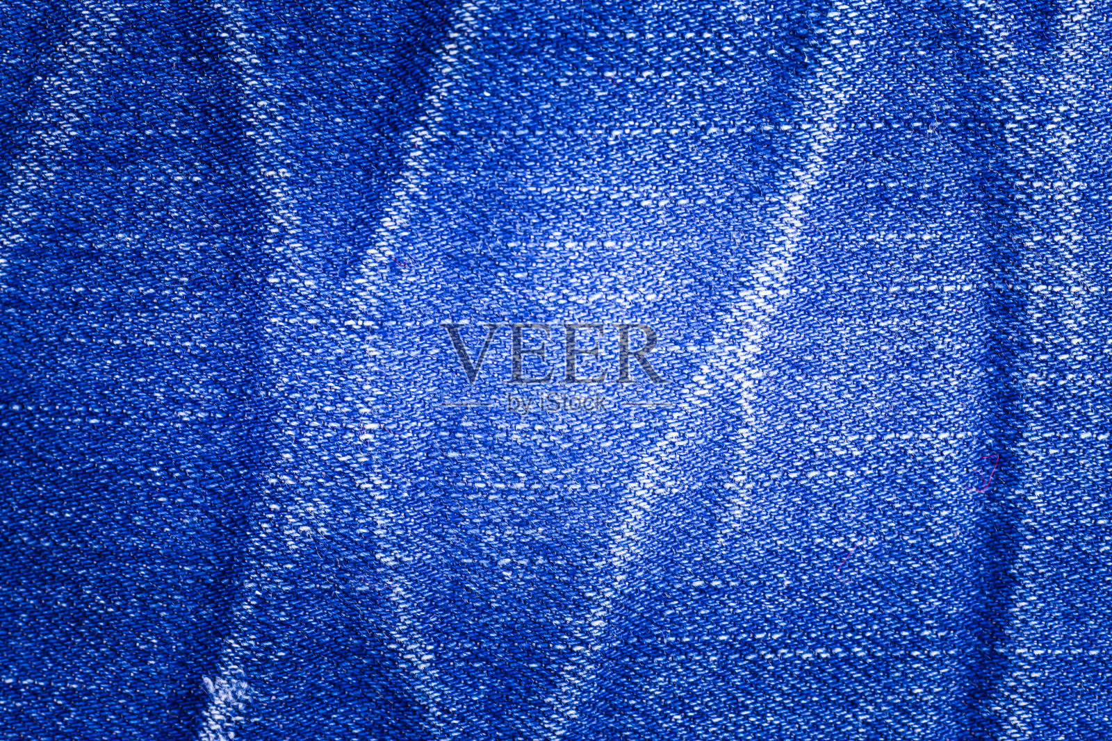 蓝色牛仔裤纹理背景。照片摄影图片