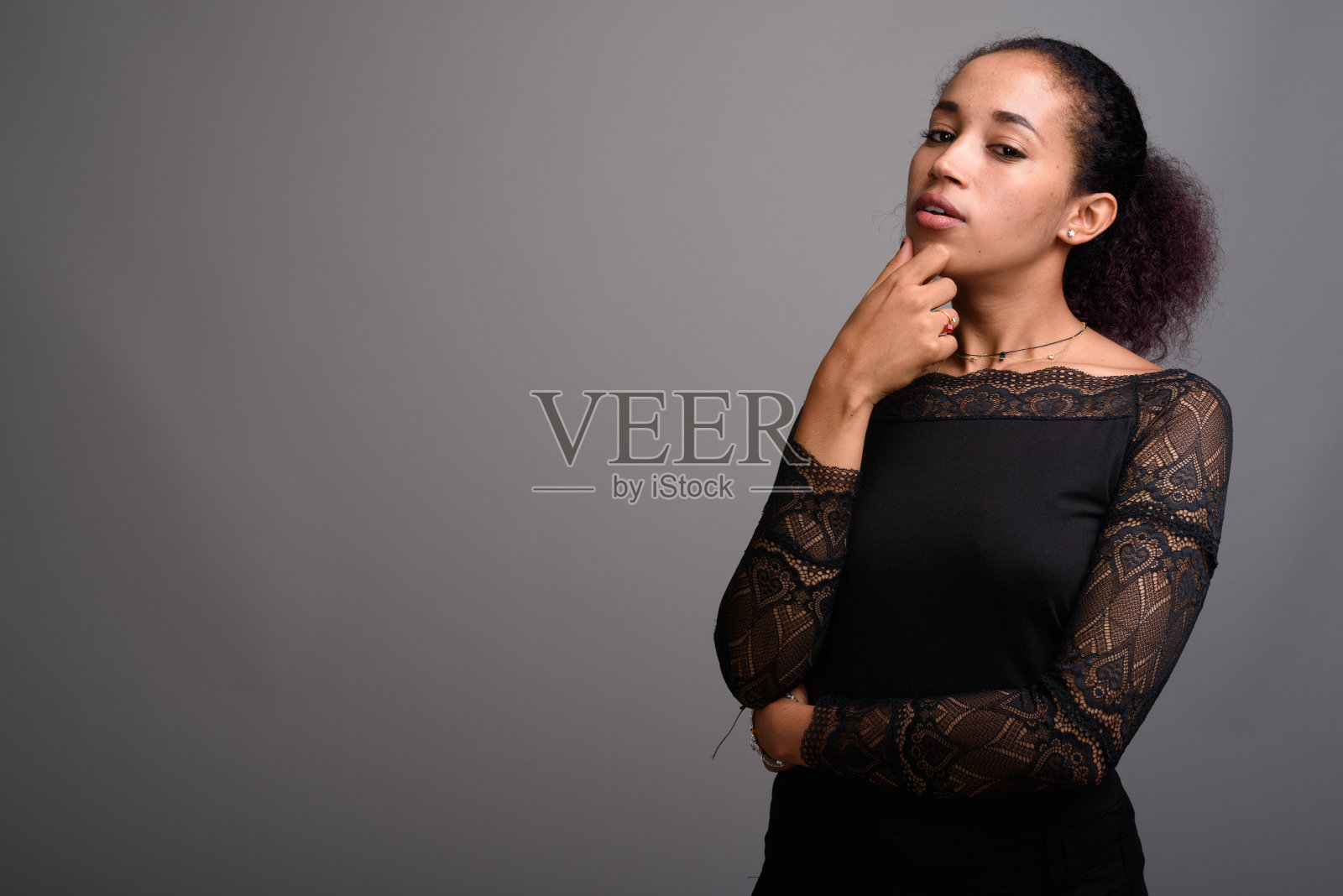 在灰色背景下拍摄的年轻美丽的非洲妇女照片摄影图片