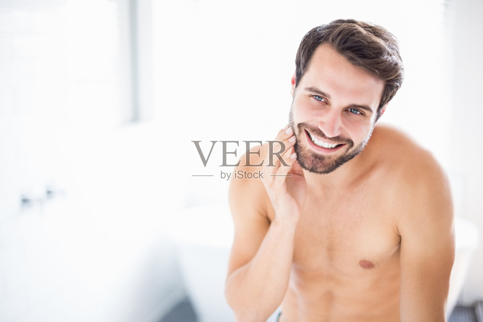 一个男人在浴室里检查他的胡茬照片摄影图片