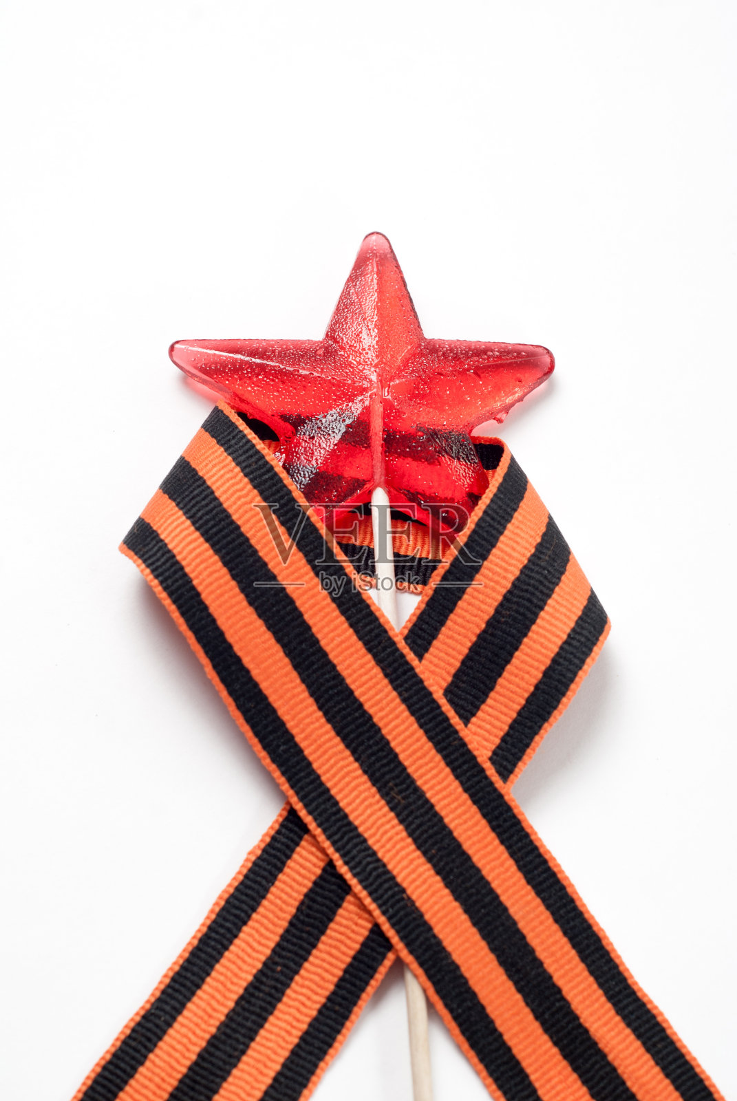 星星形状的糖果，棒子上的红色糖果，照片摄影图片