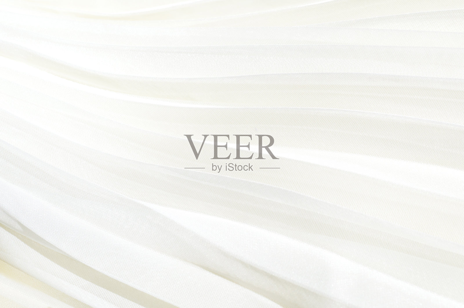 白色百褶裙的细节。白布背景打褶照片摄影图片