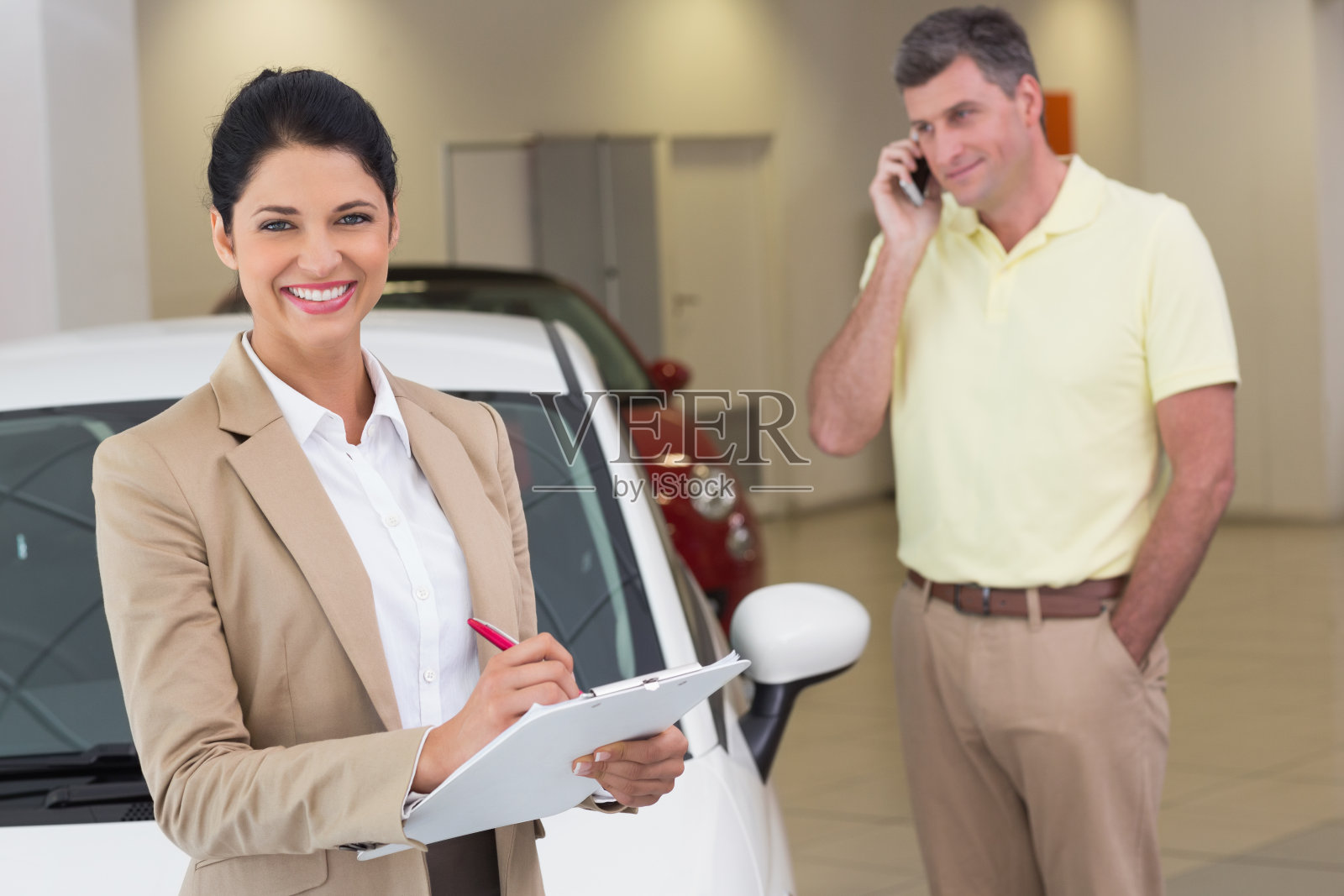 微笑的女商人在写字板上写字照片摄影图片