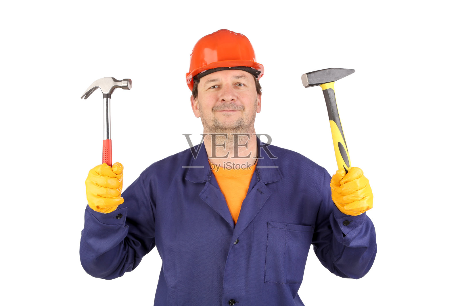 戴着安全帽拿着锤子的工人。照片摄影图片