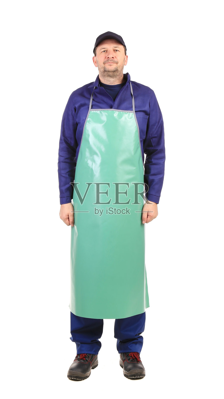 穿着蓝围裙的工人。照片摄影图片