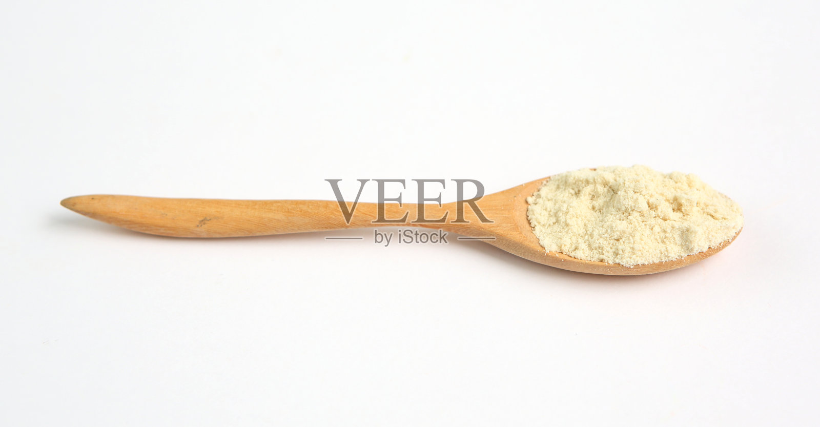 奶粉在木勺在白色的背景照片摄影图片