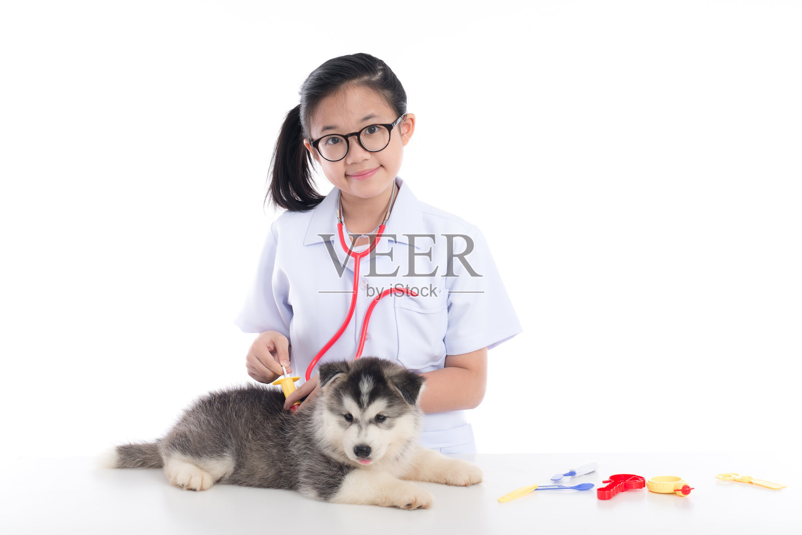 亚洲小孩扮演兽医照片摄影图片