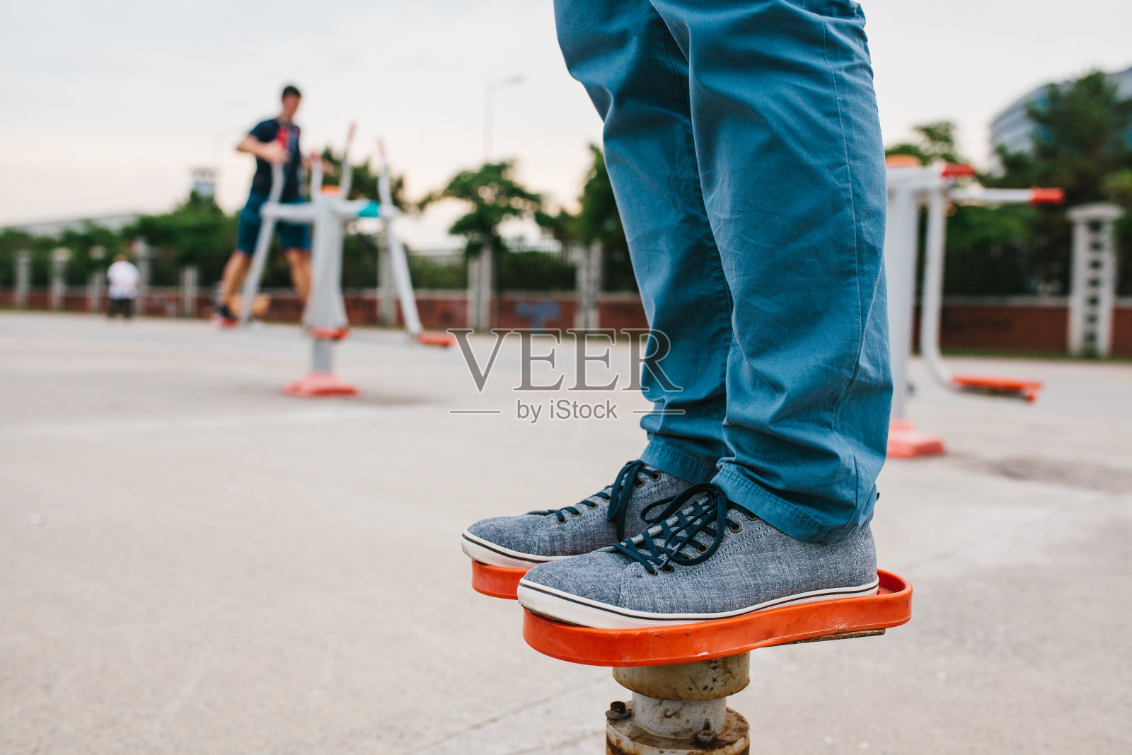 一个男人在城市的露天运动器材上训练。人人享有健康生活方式和运动训练的概念。公共场所可用的运动器材。照片摄影图片