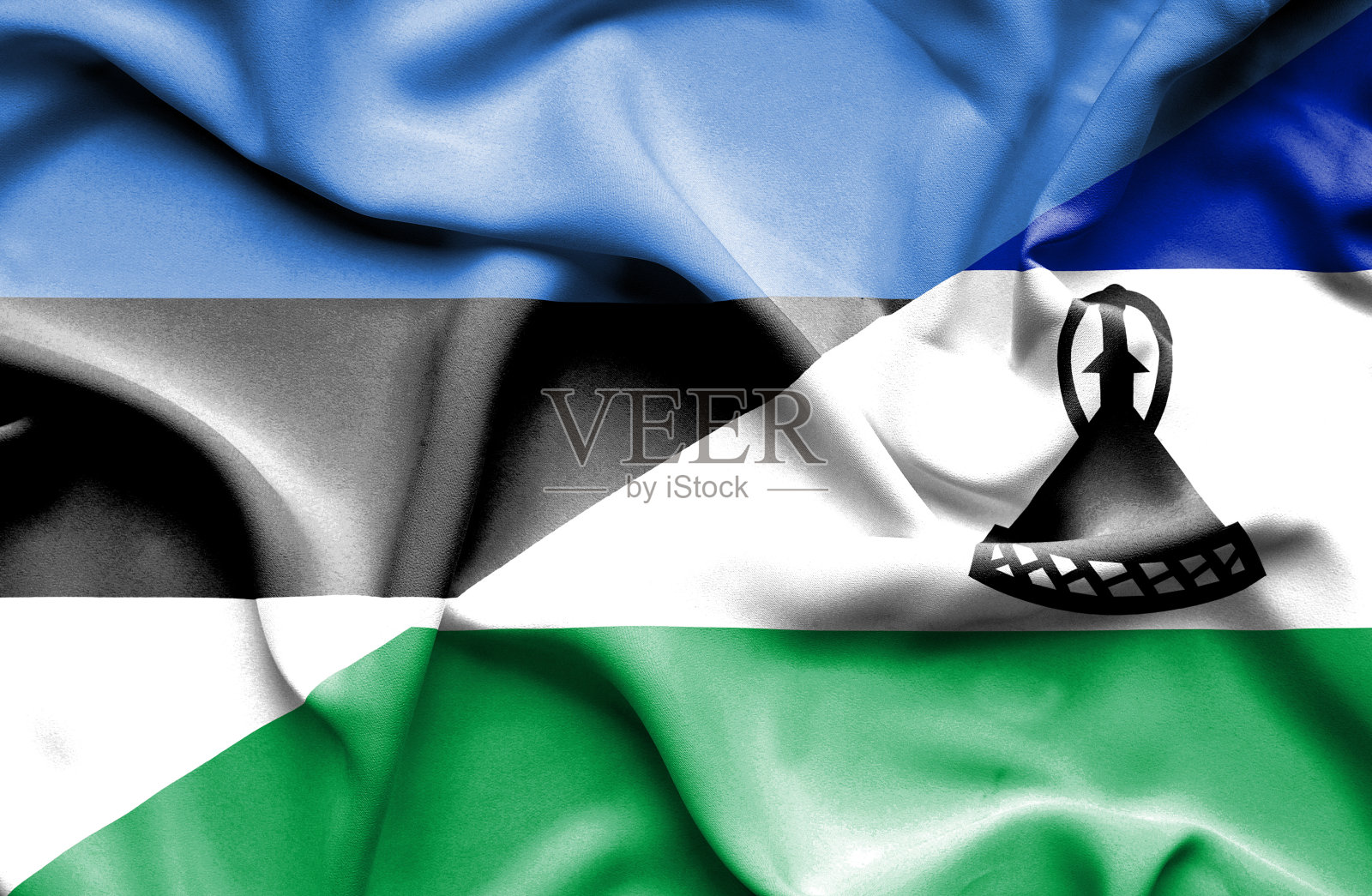 挥舞着莱索托和爱沙尼亚的旗帜照片摄影图片