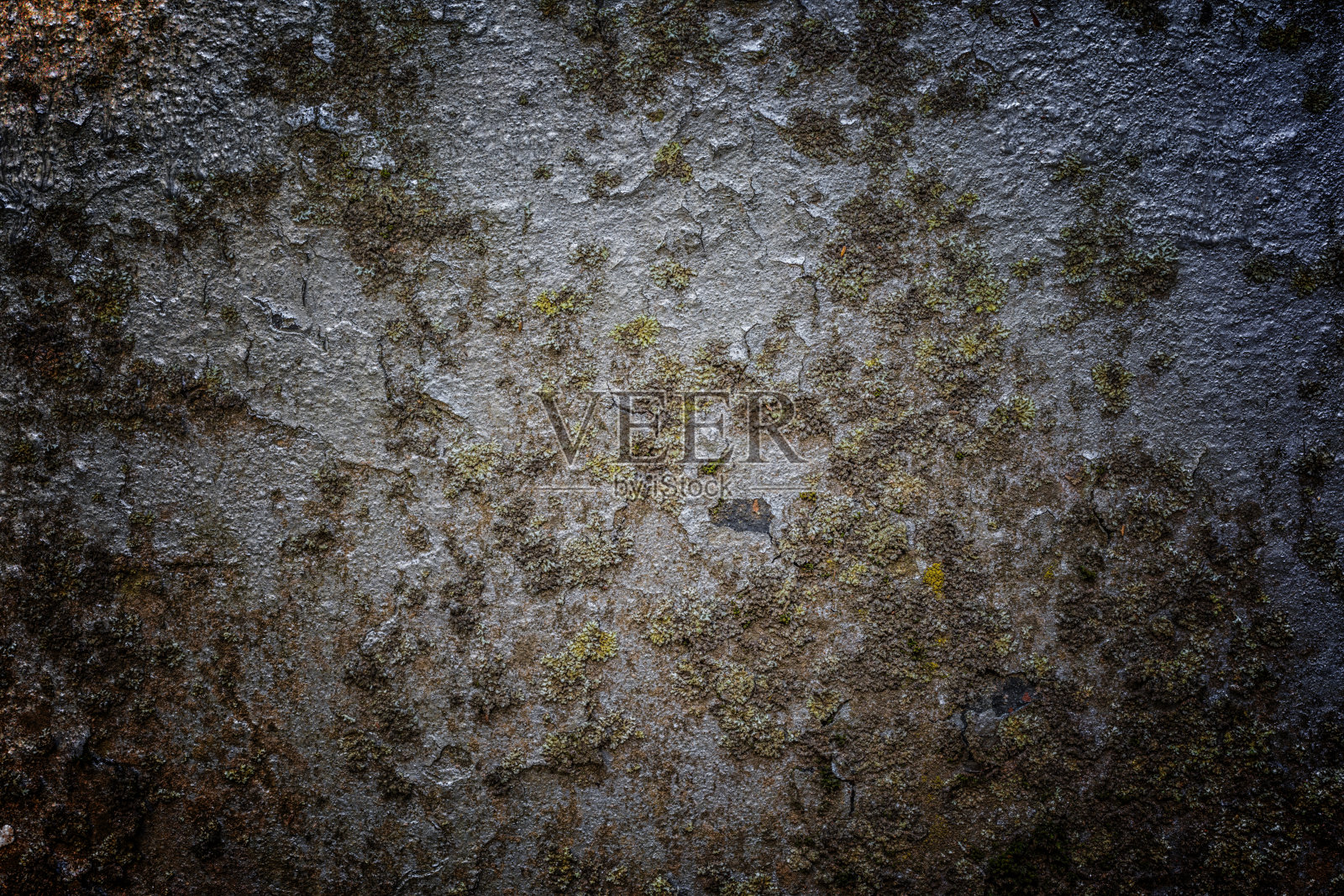 一堵未修的旧混凝土纪念碑墙。抽象的自然图案纹理，具有开裂和多色剥落照片摄影图片
