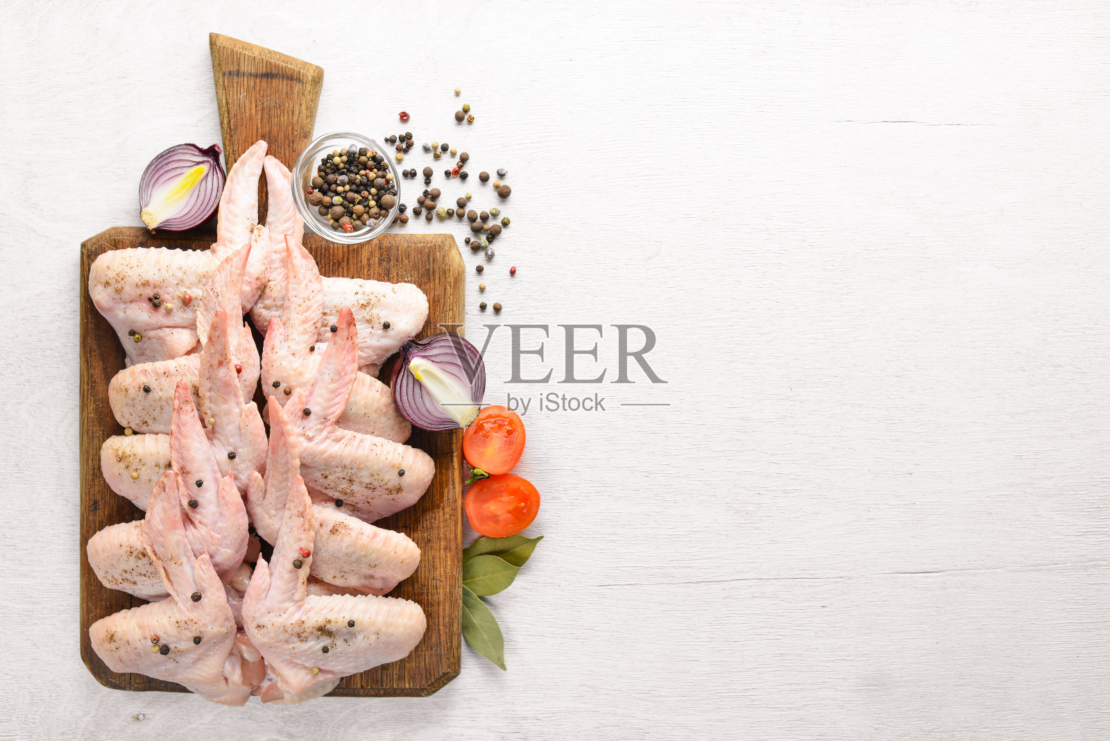 生鸡翅加香料。在木质表面。前视图。照片摄影图片