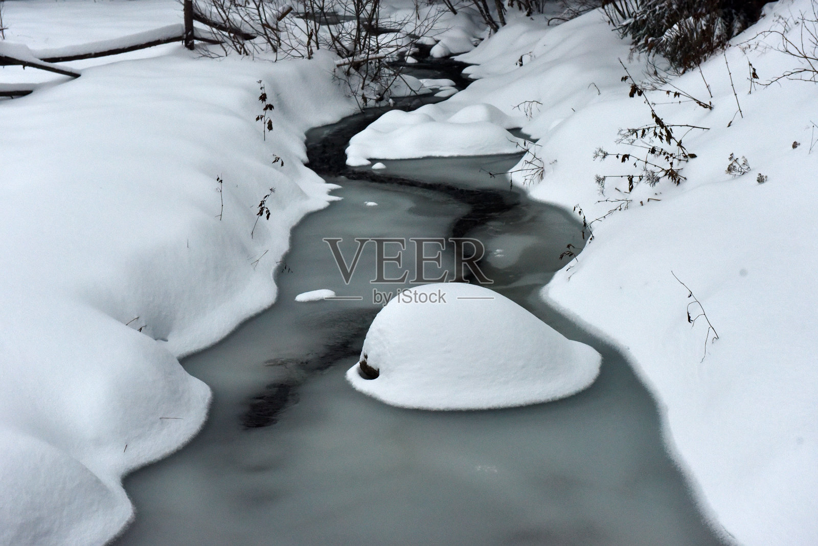 溪水小，河面上覆盖着雪照片摄影图片