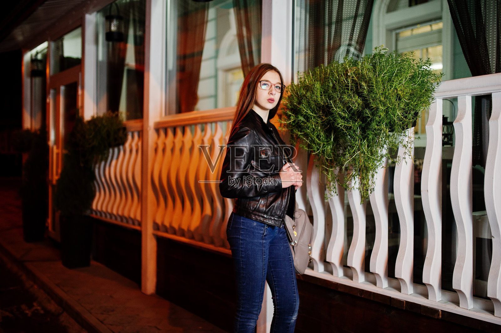 晚上的肖像女孩模特穿着牛仔裤和皮夹克照片摄影图片