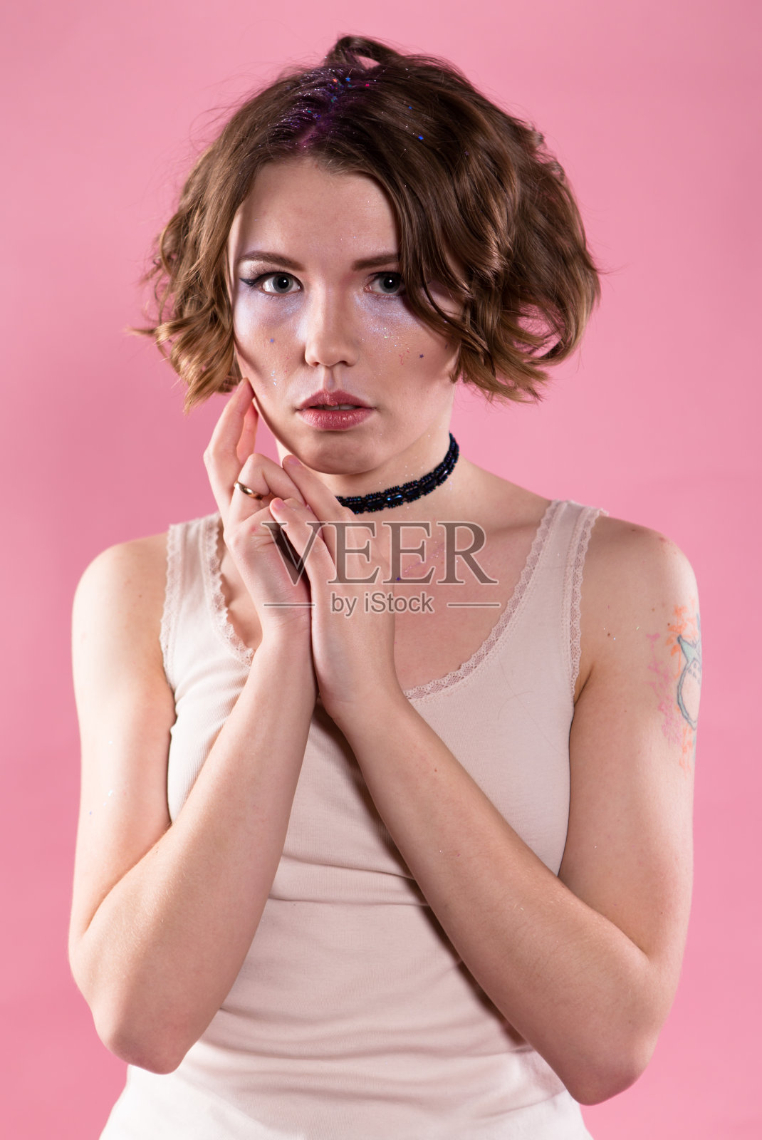 穿着衬衫和颈链的年轻女子的肖像。照片摄影图片