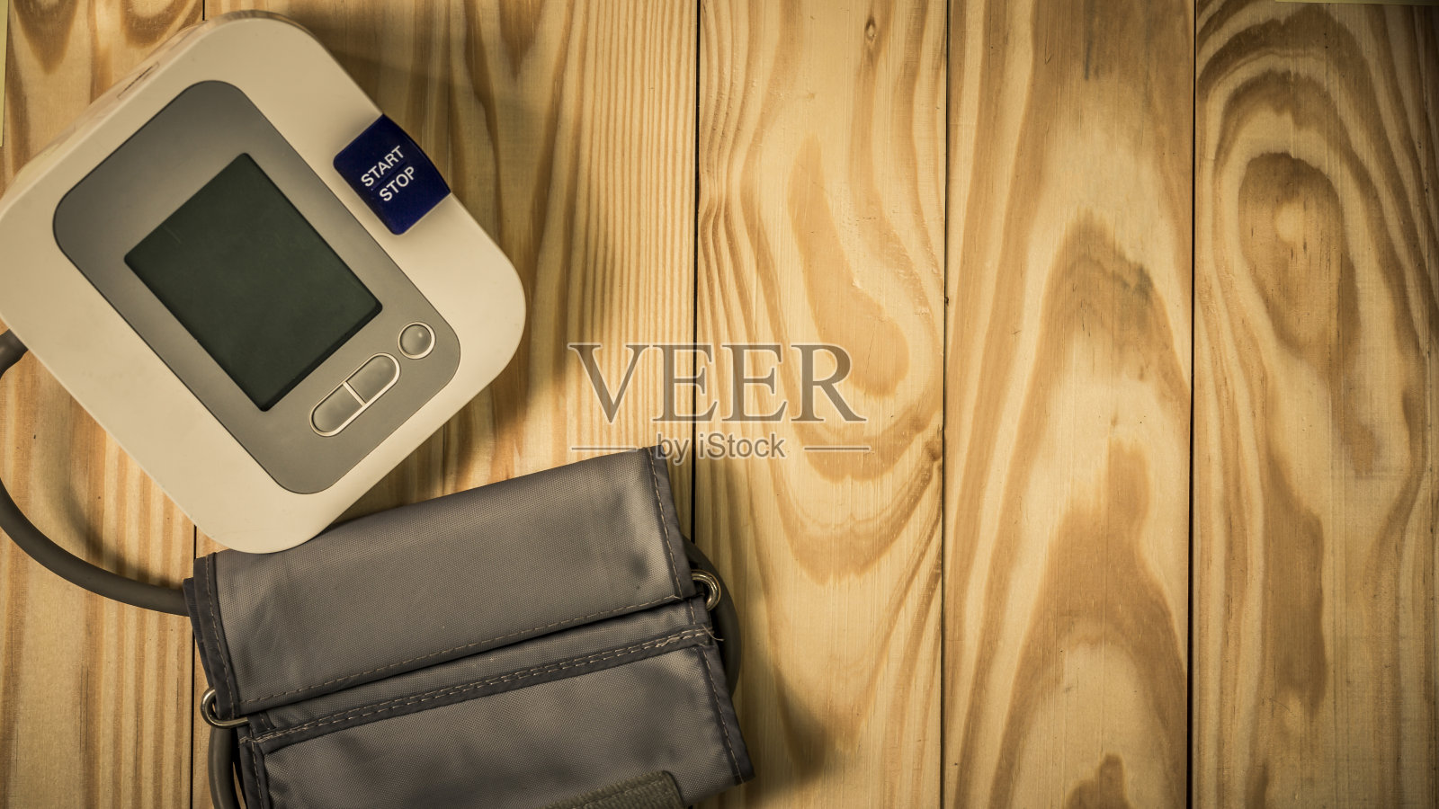 空拷贝空间上面的真实纹理松木桌子与便携式血压测量装置照片摄影图片
