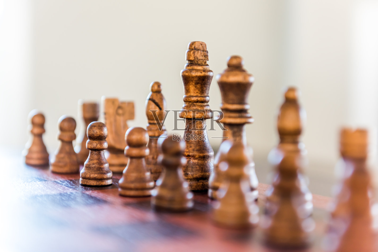 在阳光下的桌子上的木制棋子的特写，柔软的散焦照片摄影图片