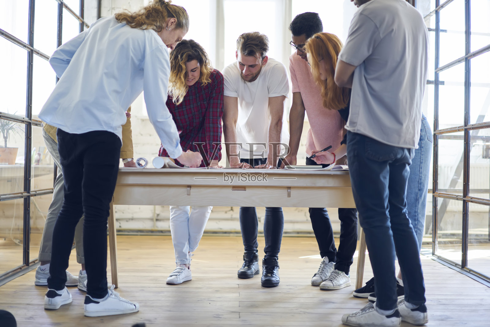 男同学和女同学在迷失的室内办公室的头脑风暴会议中改进作业项目的蓝图，寻找创造性的解决方案来规划，同事们一起工程照片摄影图片