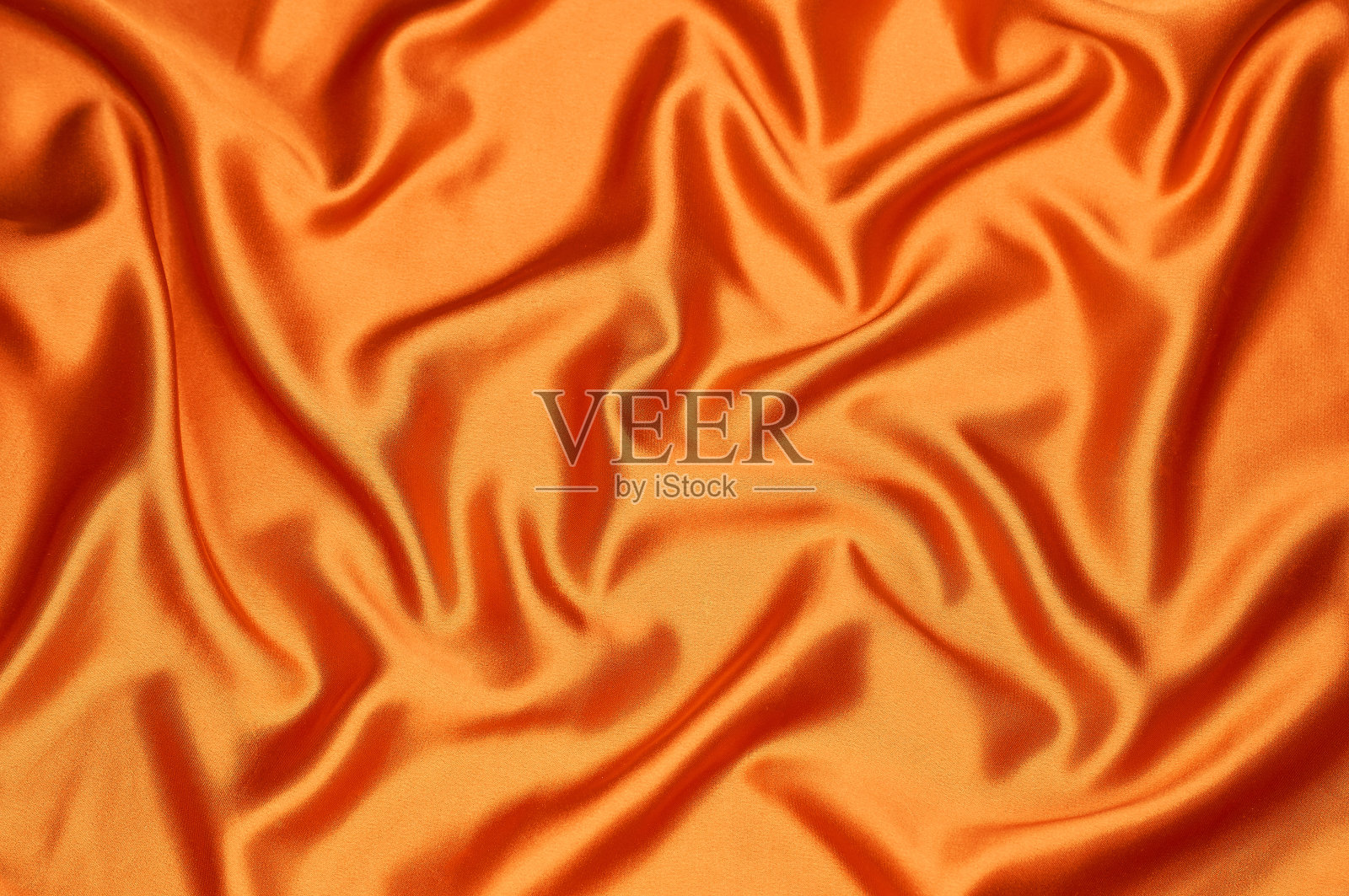 鲜亮的橘黄色丝织物溢流照片摄影图片