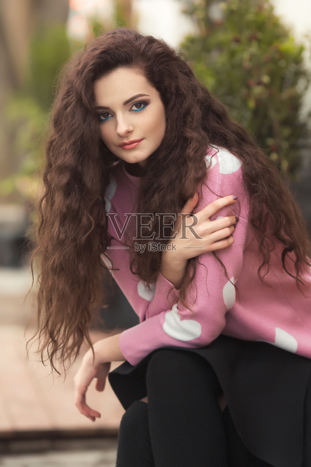 肖像年轻时尚的卷发女人独自在可爱的套头衫与心照片摄影图片