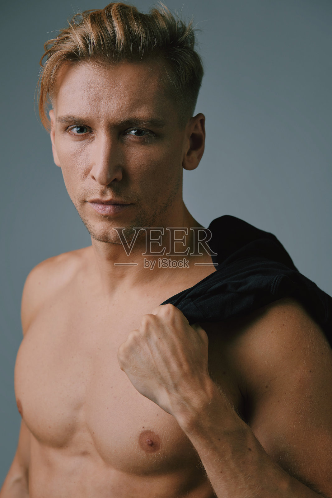 英俊的肌肉年轻人在工作室摆姿势照片摄影图片