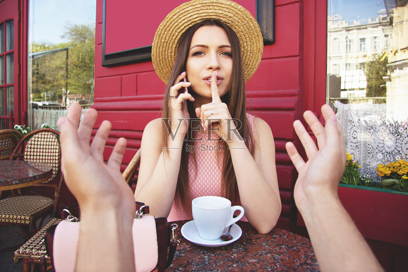 嘘，小声点。第一个人看女人约会在法国古董咖啡馆与不高兴的男人讲电话，并要求保持沉默。照片摄影图片