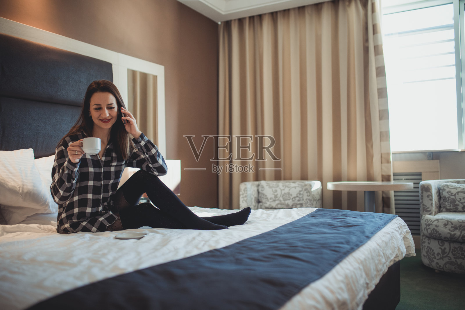 在酒店房间里打手机照片摄影图片