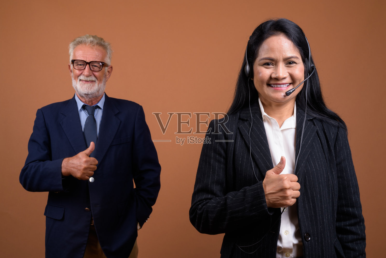 在彩色背景下拍摄成熟的多民族商业夫妇照片摄影图片