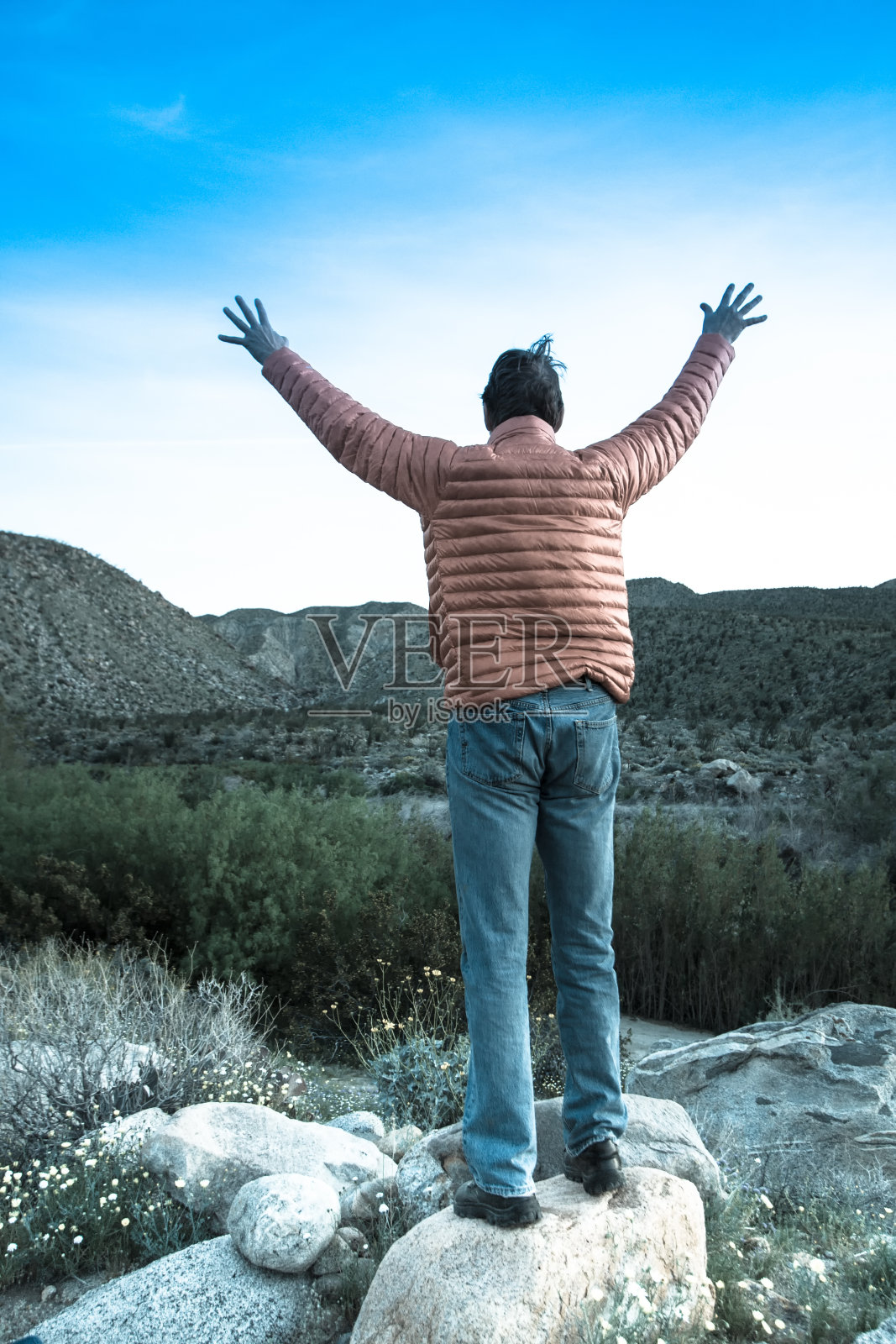 荒野的胜利:黎明的人类，幸福地举起臂膀照片摄影图片