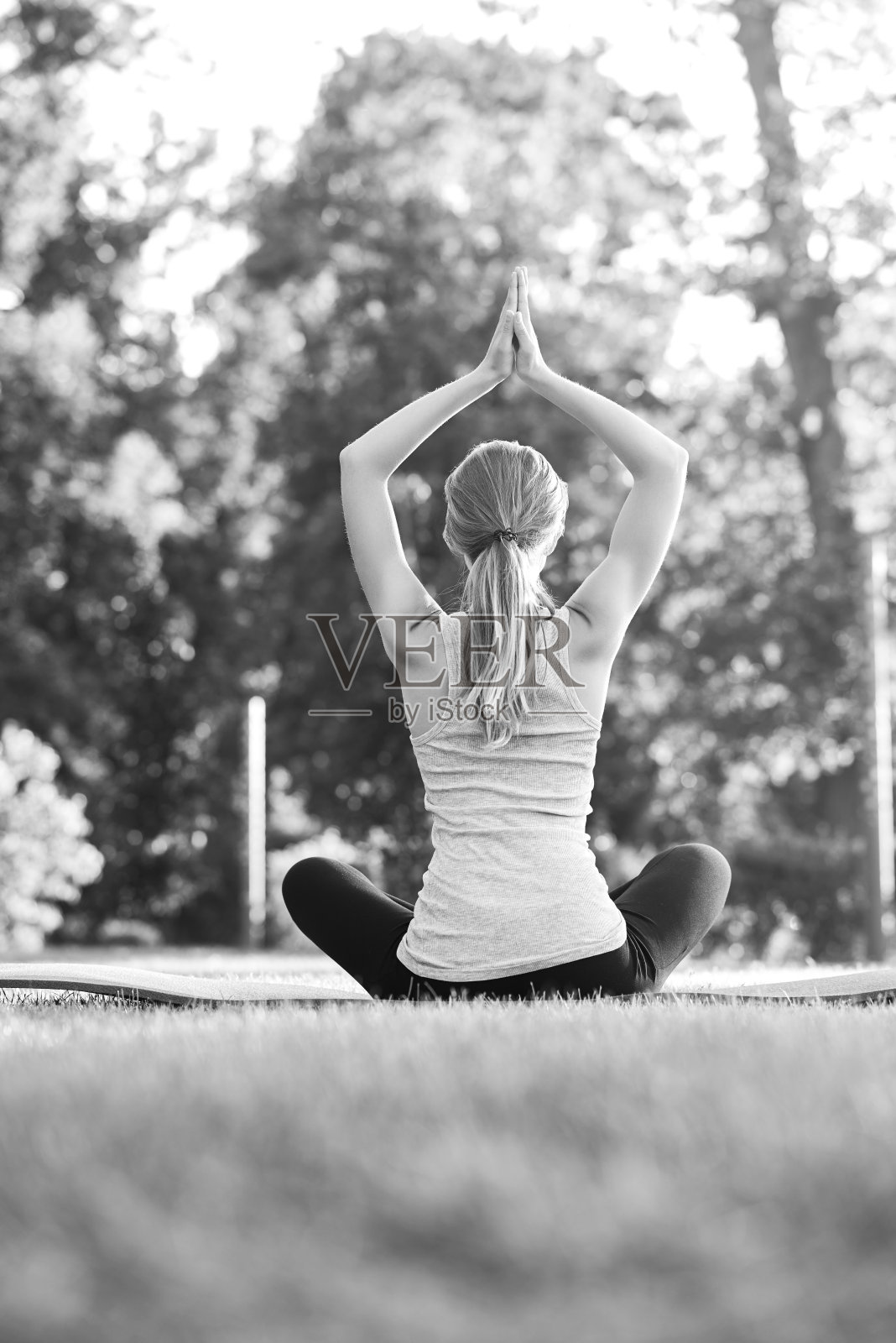 一个年轻女子在公园里练瑜伽照片摄影图片