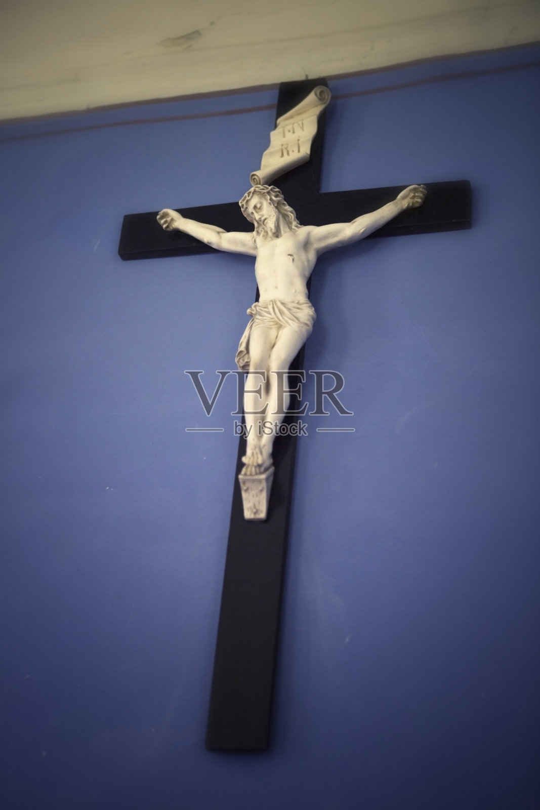 蓝墙上的耶稣十字架照片摄影图片