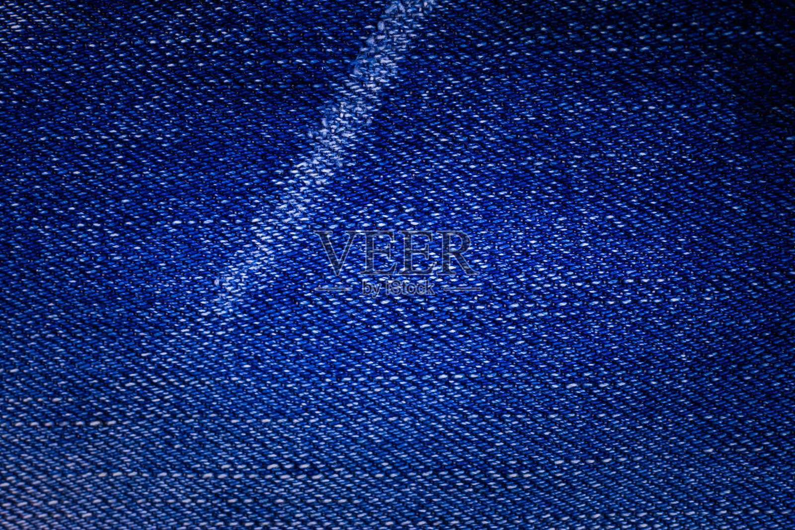 蓝色牛仔裤纹理背景。照片摄影图片