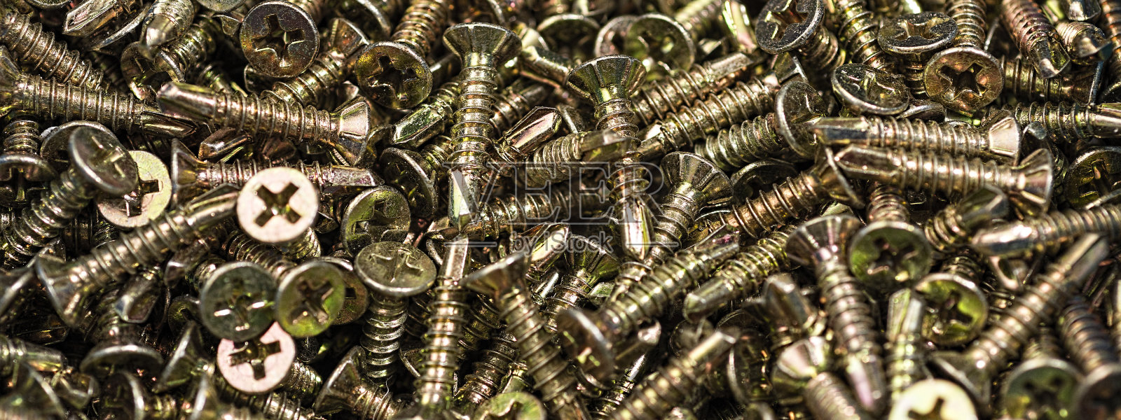 黄金螺丝宏观特写。背景图案。照片摄影图片