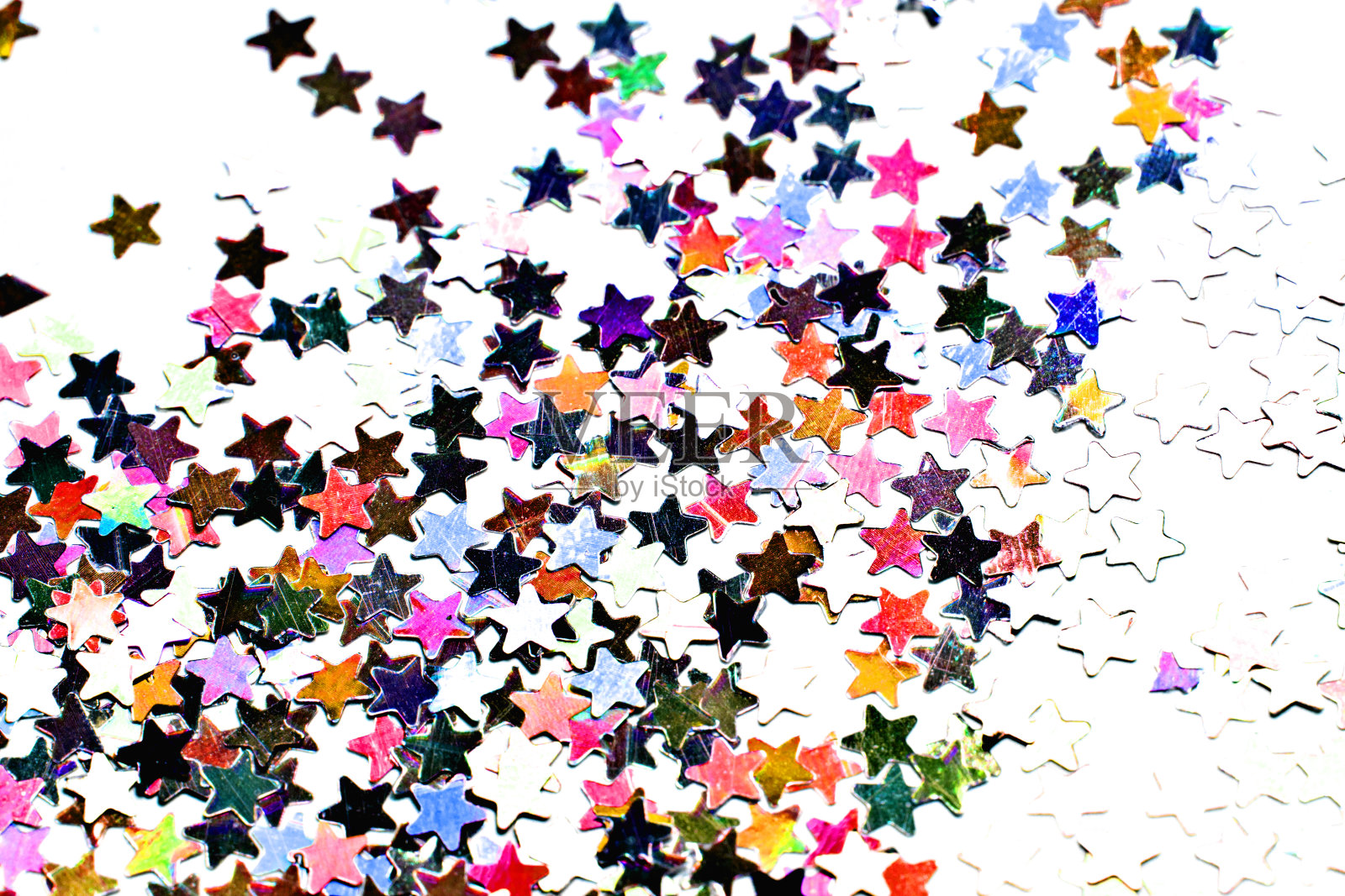 星星形状的闪光五彩纸屑在白色的背景照片摄影图片