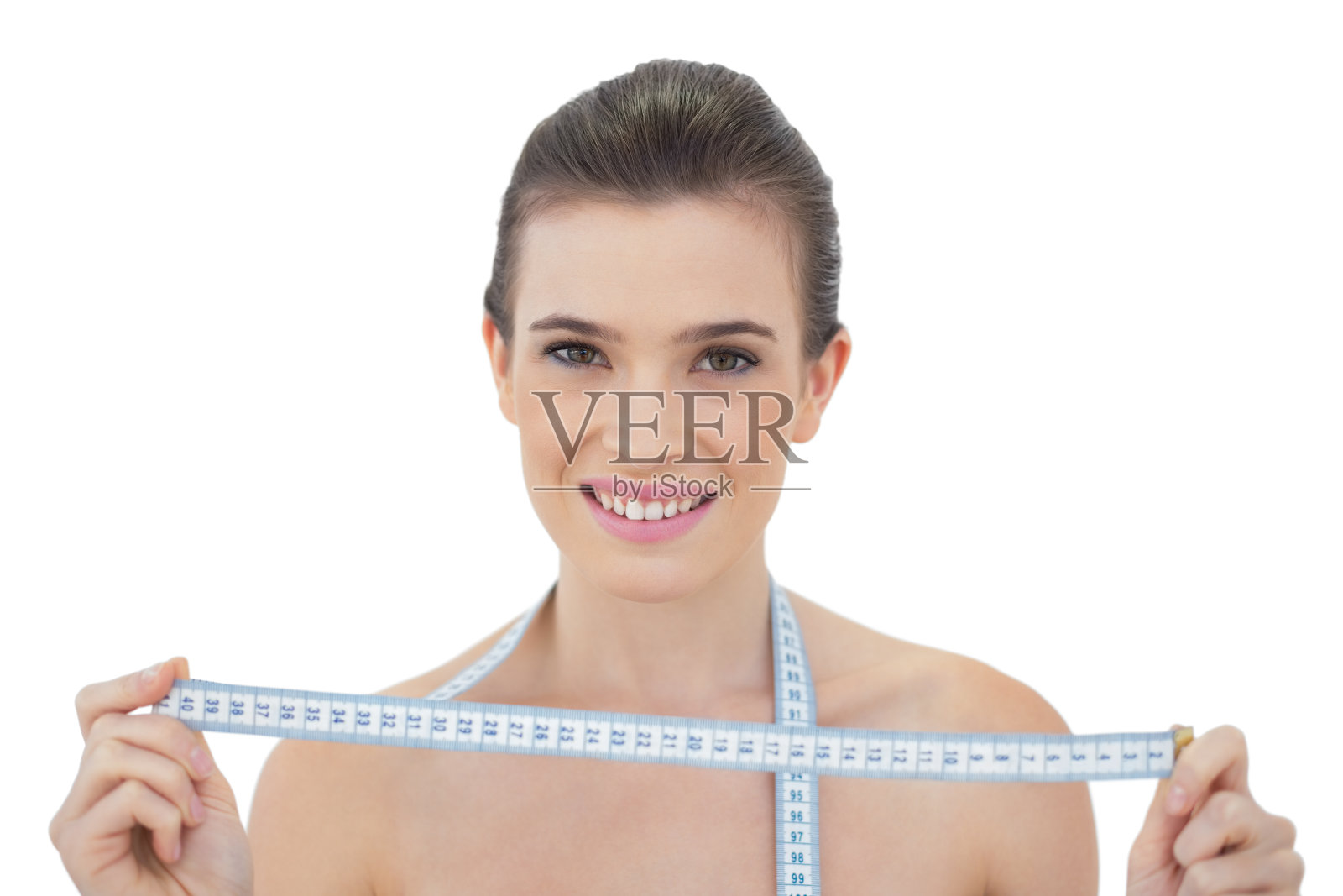 迷人的自然棕色头发的模特拿着一个测量尺照片摄影图片