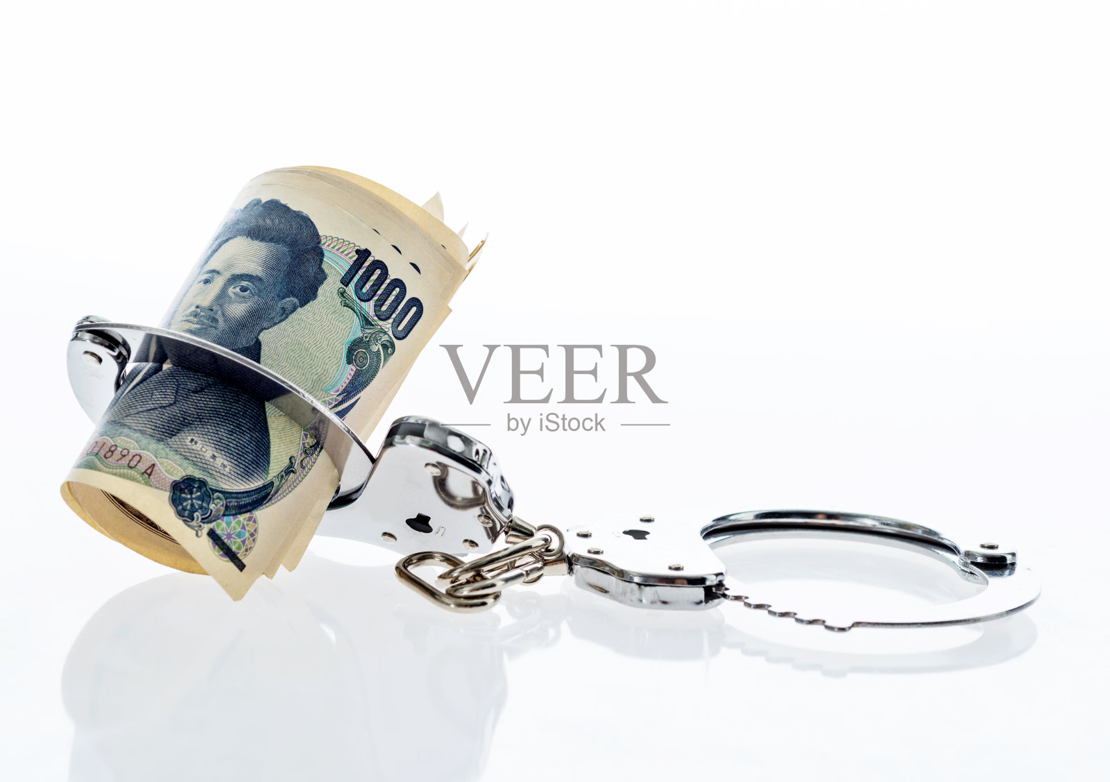 戴着手铐的日元钞票照片摄影图片