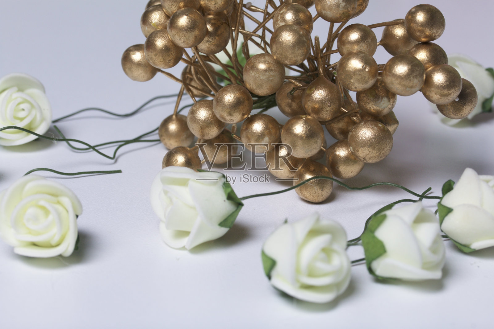 一束人造花.白色背景上的米色玫瑰