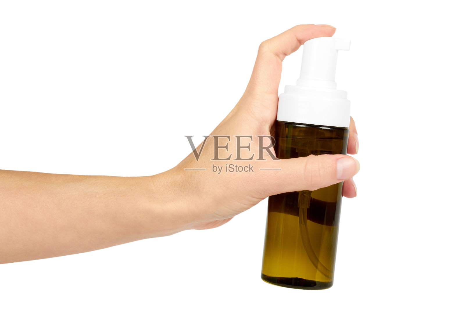 塑料喷瓶与泵在手孤立在白色背景。面部护理泡沫器。装有身体乳液的容器。照片摄影图片