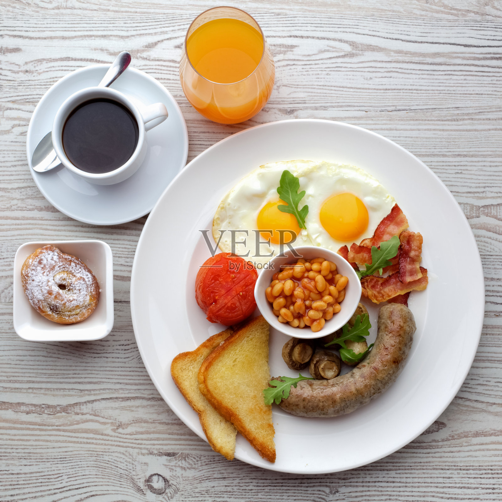 传统的英式早餐-单面煎蛋，香肠，豆类，蘑菇和培根照片摄影图片