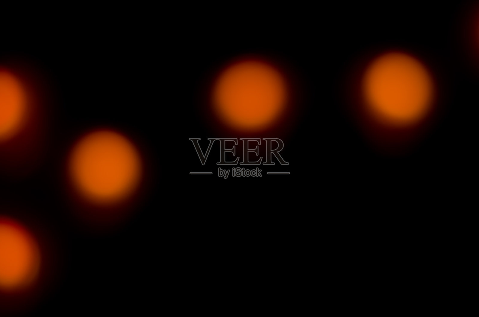 在黑暗中橙色光的抽象模糊照片摄影图片