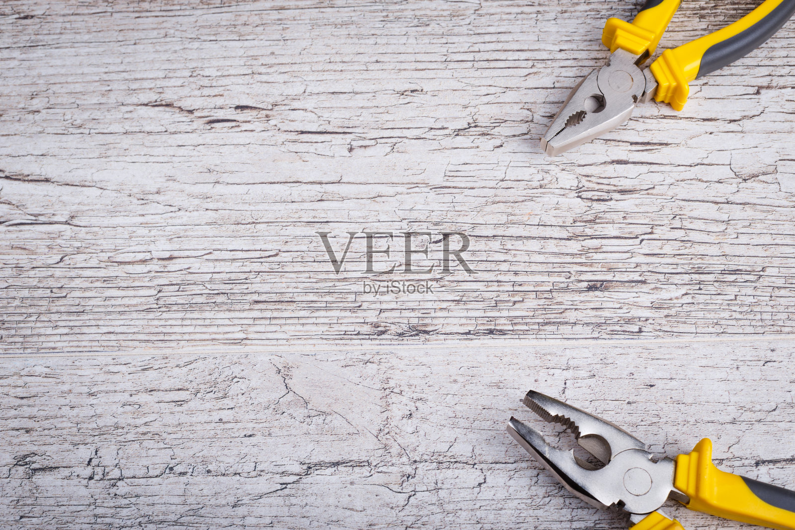 钳子在右边角落的灰色背景。从上面的观点照片摄影图片