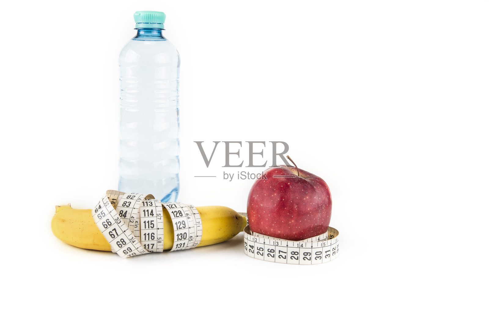 减肥、健康饮食、食物和减肥概念 - 香蕉苹果和卷尺的特写照片摄影图片
