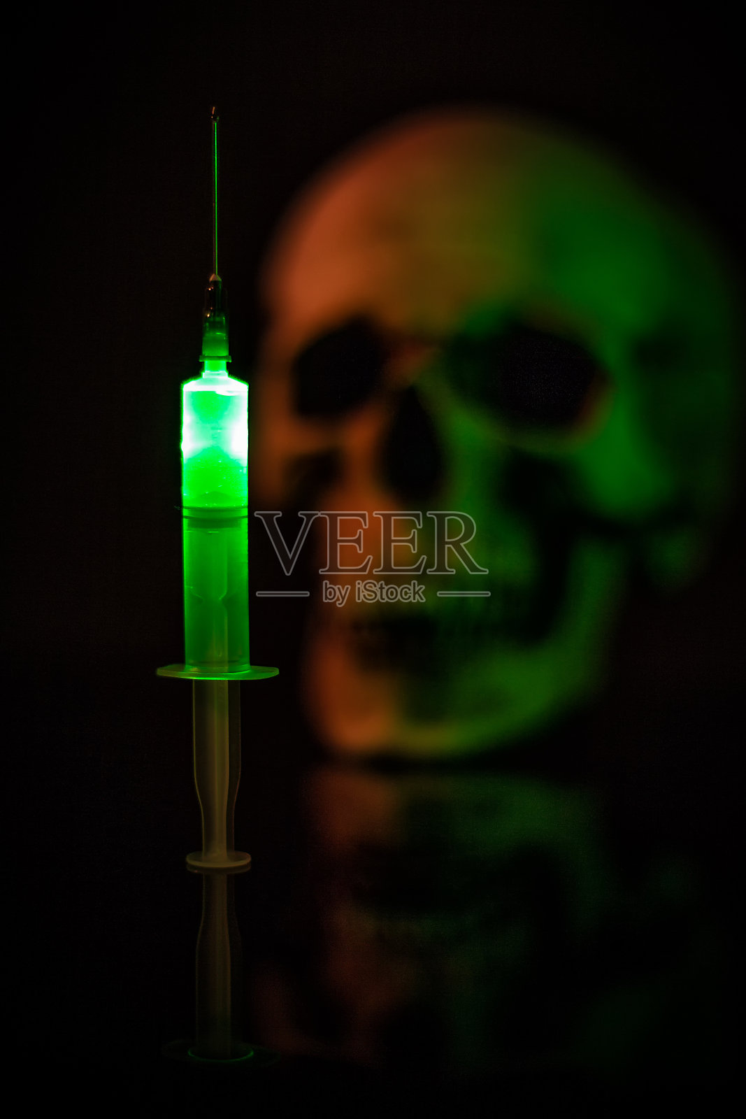 人头骨上的注射器照片摄影图片