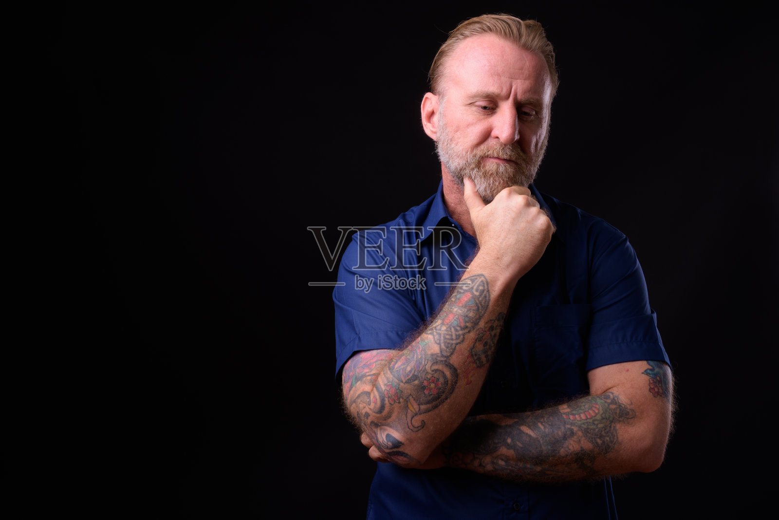有胡子和纹身的成熟男人在思考照片摄影图片