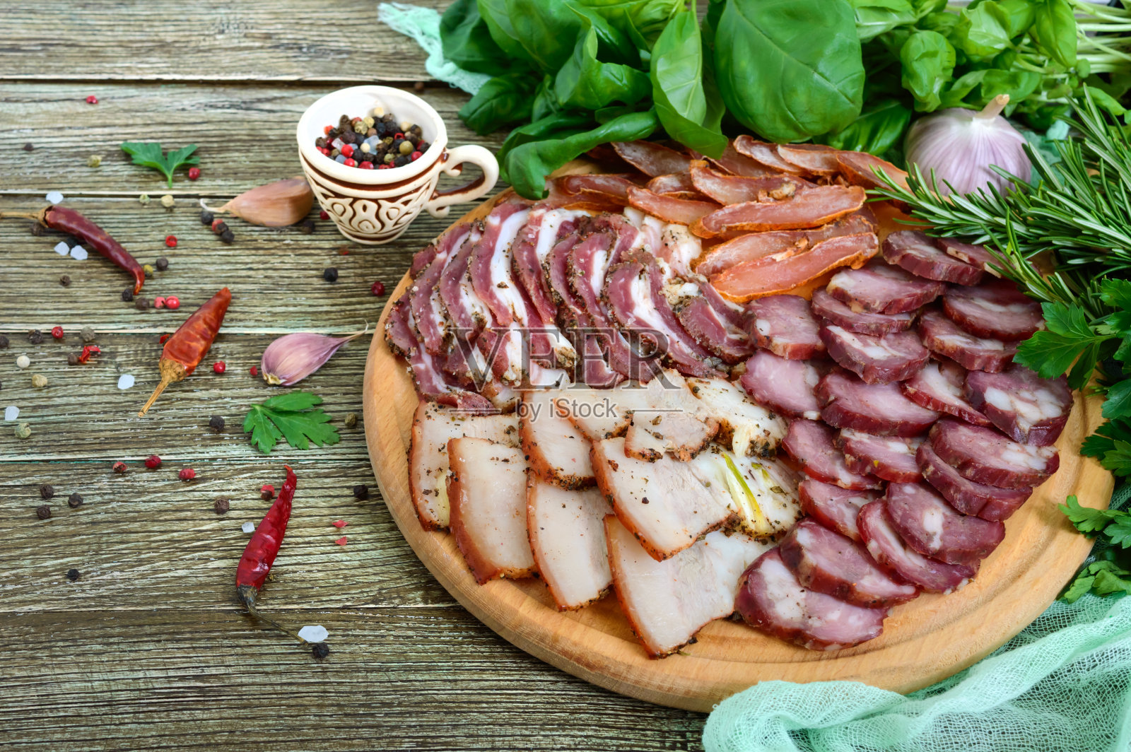 大的肉。自制熏猪肉牛肉香肠，咸培根，木棒切成片，配上香料和香草。照片摄影图片